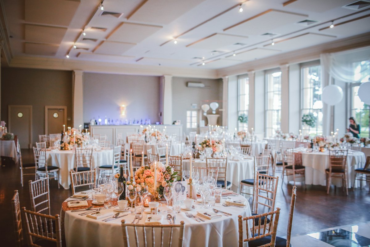Banquet room of round tables dressed in floor-length table linen