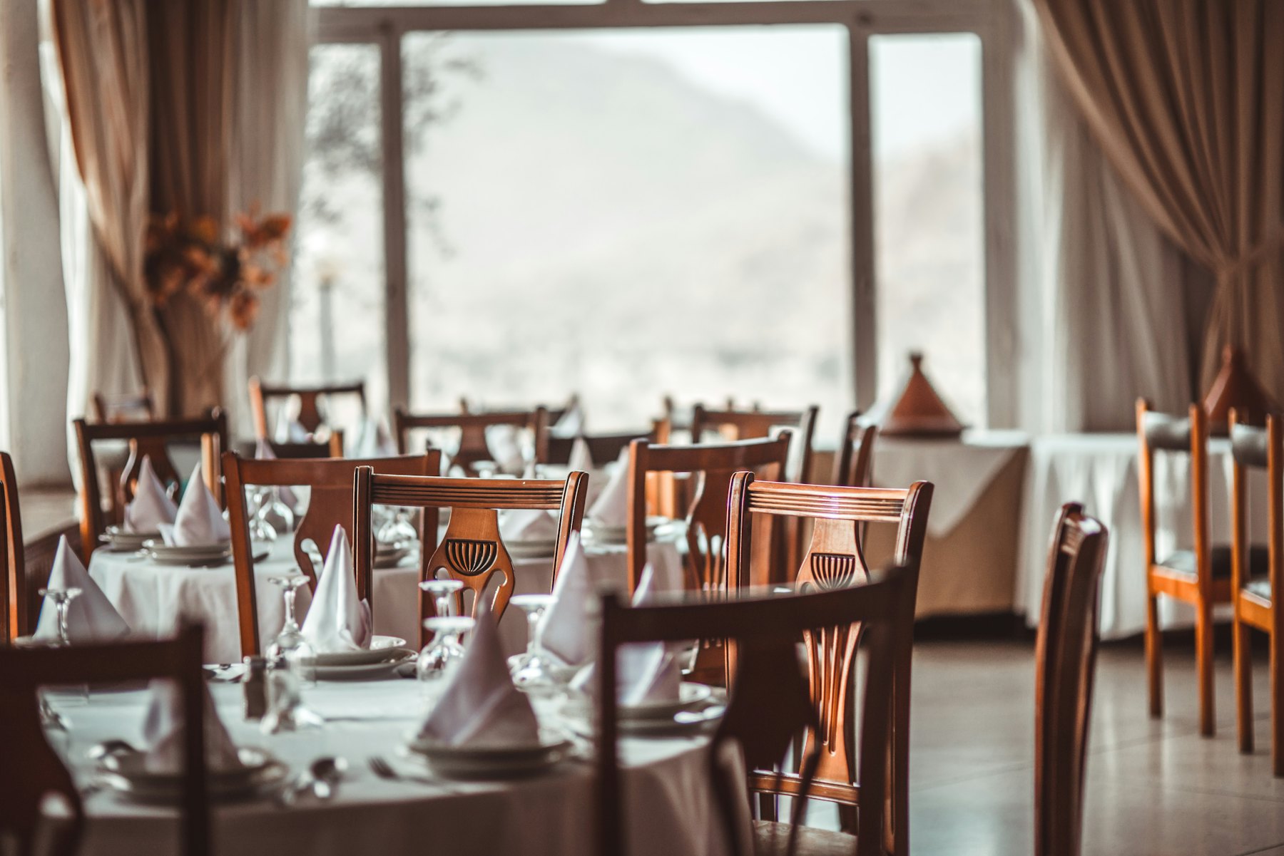 Fine dining restaurant tables dressed in white table linen