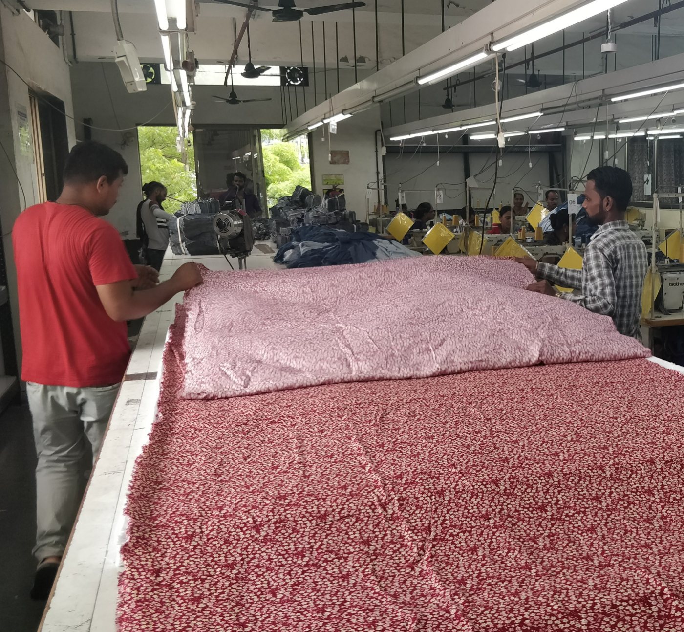 Spreading printed fabric across the cutting table